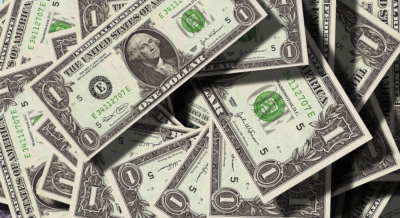 A close-up of US dollar bills representing the impact of a Fed balance sheet reduction