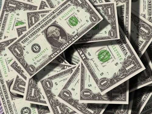 A close-up of US dollar bills representing the impact of a Fed balance sheet reduction